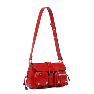 Detail view of red Y2K shoulder bag with silver studs and small zipper pockets