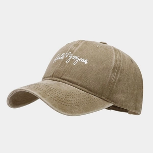 Close-up of Hello Gorgeous embroidery on vintage washed cotton baseball cap texture