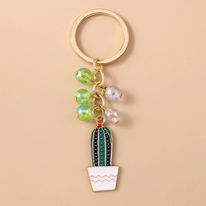 Close-up of pastoral green cactus keychain with colorful beads on a gold chain