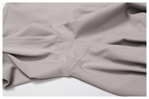 Detailed close-up of high-quality four-needle six-thread stitching and gusset on yoga pants