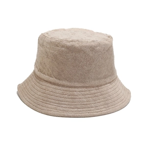 Light brown terry cloth bucket hat with reinforced stitching on a white background