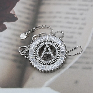 Macro shot of silver-plated letter A pendant with sparkling zircon micro-pave setting