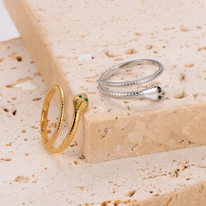 French vintage snake rings in gold and silver with green stone eyes on stone base