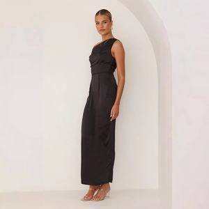 Elegant close-up of a black satin one-shoulder maxi dress with a slim-fit silhouette