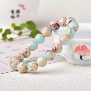 Detailed close-up of Sea Sediment Jasper beaded bracelet with vibrant blue and red textures