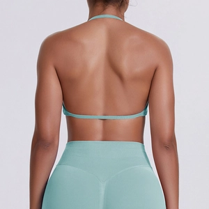 Detail of cross-back halter sports bra and high waist leggings in breathable mint fabric