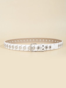 Detailed macro view of white faux leather belt with silver metal eyelets and rivets decoration
