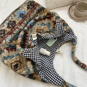 Detail showing checkered inner lining and large capacity of the ethnic patterned tote bag