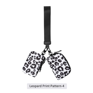 Detail of leopard print nylon wrist bag with dual zip compartments and metal clasp