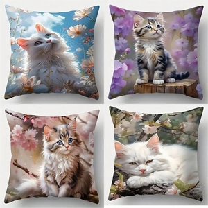 Close-up of four linen pillow covers featuring artistic cat and flower illustration prints