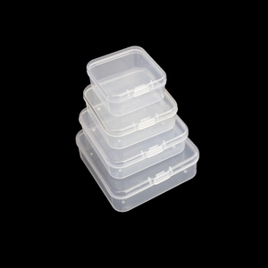 Stack of four different sized transparent PP plastic storage boxes on black background