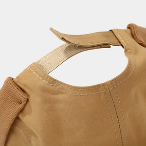 Close-up of the adjustable velcro strap and stitching on the khaki brimless docker cap