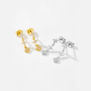 Detail of S925 silver drop earrings with triple clover charms and white zircon stones
