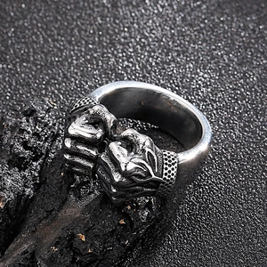 Macro shot of retro stainless steel fist bump ring with detailed industrial textures