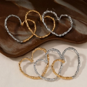 Exaggerated 316 stainless steel hollow heart earrings with irregular lava texture in gold and silver
