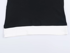 Close-up of the black and white double-layer hem with fine knitted texture details