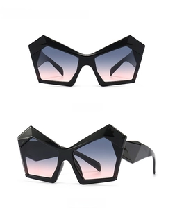 Oversized geometric sunglasses with black frames and grey pink gradient lenses