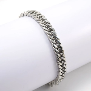 Macro view of silver stainless steel Cuban link bracelet with high polish finish