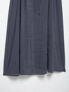 Detailed close-up of dark grey V-neck dress hem with drawstring and subtle fabric texture