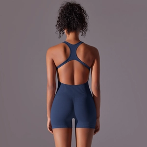 Detail of deep blue seamless yoga jumpsuit showing racerback cutout and ribbed texture
