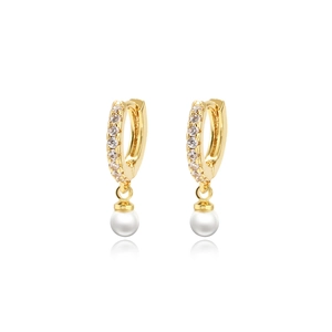 Golden pearl hoop earrings with sparkling cubic zirconia on a white reflective background