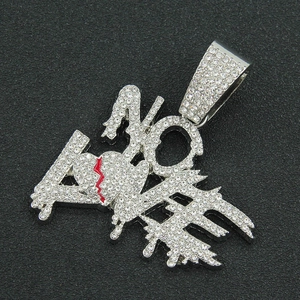 Macro shot of silver paved rhinestone 'NO LOVE' letter pendant with red heart detail