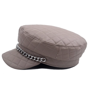 Detail of quilted PU leather newsboy hat with silver chain and vintage army style