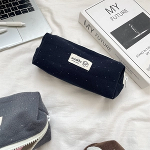 Close-up of wool felt polka dot pencil cases with a zipper on a lifestyle desk background