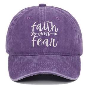 Macro detail of 'faith over fear' white embroidery on purple washed cotton baseball cap