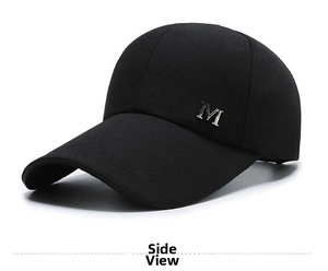 Detailed side view of black canvas baseball cap featuring a silver metal M logo decoration