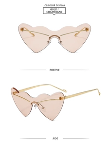 Detail view of heart-shaped rimless sunglasses in champagne tint and gold metal frame