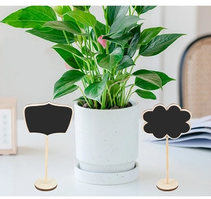 Mini wooden chalkboard signs with wavy edges and cloud shapes on natural round bases