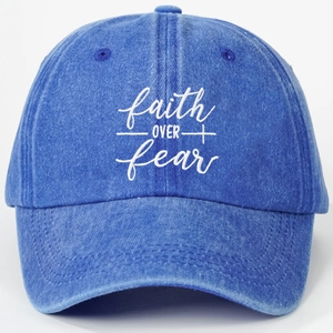 Washed blue baseball cap featuring faith over fear embroidery in a vintage style