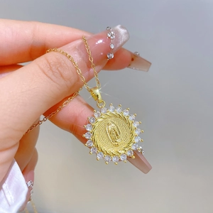 Gold Virgin Mary portrait necklace with sparkling crystal halo on a dainty steel chain