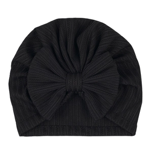 Close-up of black ribbed knit baby turban featuring a large decorative soft bow