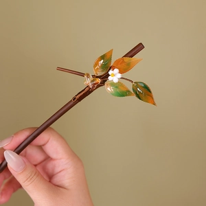 Detail of bamboo hairpin with handcrafted white flower and butterfly ornaments