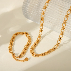 Detail shot of the golden stainless steel U-link chain necklace and bracelet jewelry set
