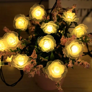 Detail of warm yellow glowing LED rose flower lights in a romantic decorative setting