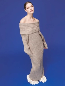 Macro detail of beige ribbed knit texture and elegant off-the-shoulder neckline