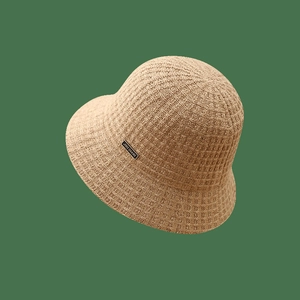 Knitted wool bucket hat for women in beige featuring a stylish metal logo plaque