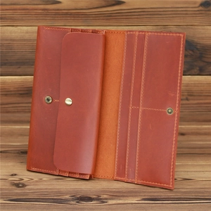 Detail of vintage crazy horse leather wallet showing card slots and snap pocket