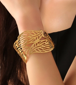 Close-up of golden irregular hollow leaf cuff bracelet featuring detailed vein patterns