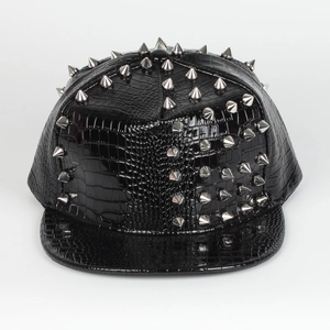 Detail of punk style black faux crocodile leather baseball cap with silver metal rivets