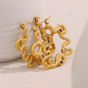 Detailed macro view of 18K gold plated wavy earrings with multicolor zircon stones