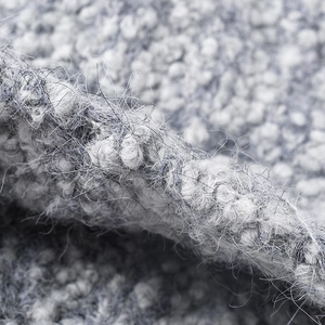 Thick winter knitted beanie with gray and white bouclé texture for outdoor warmth