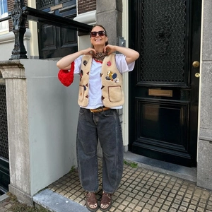 Retro beige lamb wool vest with cartoon patch, white t-shirt, and wide-leg jeans outfit