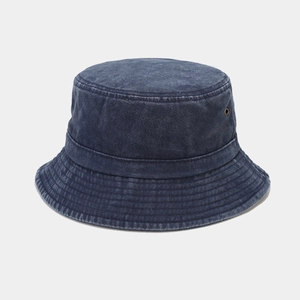 Detail of washed denim bucket hat showing metal eyelets and reinforced stitching