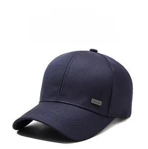 Detail of navy blue twill baseball cap with reinforced stitching and metal Sport badge