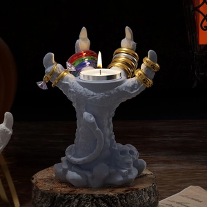 Gothic hand-shaped candle holder and ring display with skull base and snake detail