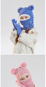 Close-up of kids winter knit balaclava hat with double pom-poms and matching gloves